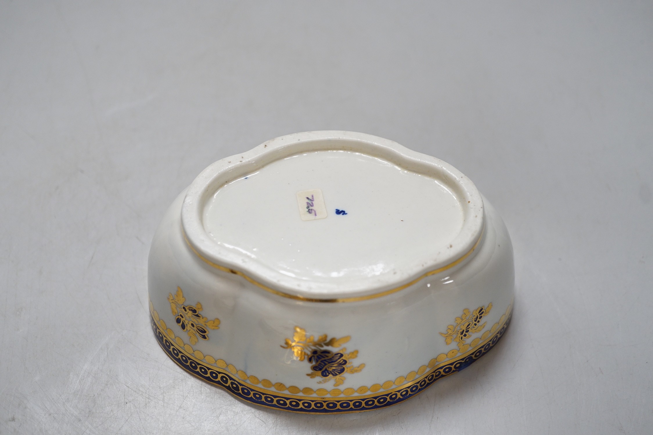 An 18th century Caughley tureen cover and stand with blue and gilt decoration, stand mis-fired to border, S mark to stand and base. 15cm wide